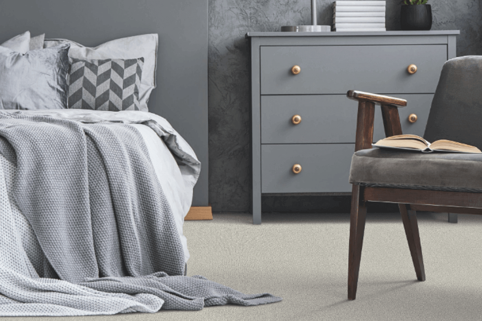 Bedroom with a neutral color scheme and loop pile carpet