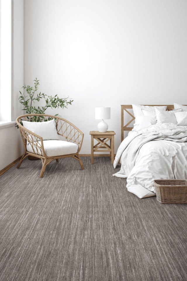 Bedroom with a neutral color scheme and pattern carpet