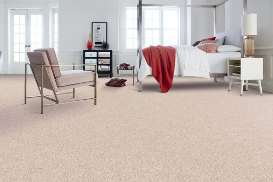 Bedroom with a modern design and frieze cut pile carpeting